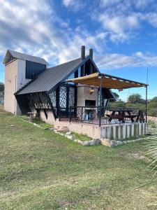 a building with a picnic table in front of it at Cabañas La vista in Cavalango