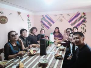 a group of people sitting around a table eating at Amantaní Elisa's lodge Puno in Puno
