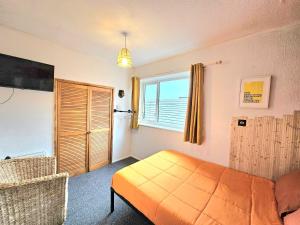 a bedroom with a bed and a window at Hotel Claytou in Blackpool