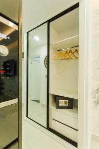 a walk in closet with a large mirror at Accra Luxury Apartments at Kass in Accra