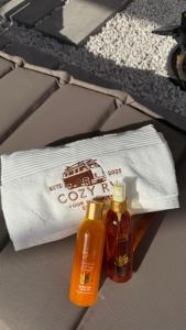 a white towel and two bottles of hair products at cozy rv in Falaj al Mu‘allá +12 photos