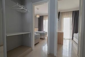 a room with a hallway with a mirror and a bedroom at M&P Apartment by RentalsPro - Nea Moudania Halkidiki in Nea Moudania