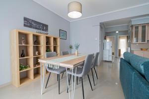 a kitchen and dining room with a table and chairs at M&P Apartment by RentalsPro - Nea Moudania Halkidiki in Nea Moudania