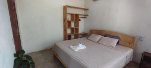 a bedroom with a bed with a white tray on it at Casa Boson in Zipolite