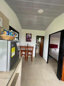 a kitchen with a table and chairs in a room at El Alpino Cabaña Glamping & Camping in Guatavita