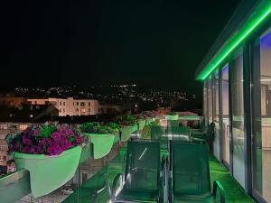 a row of plants on a balcony at night at City Boutique Hotel in Sarajevo