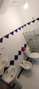 a bathroom with two toilets and two sinks in it at Dar Bouanani in Asilah +137 photos