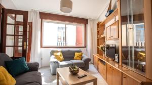 a living room with a couch and a tv at Casa Marinera en A Guarda in A Guarda +19 photos