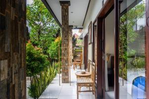 an internal view of a house with a patio with chairs at Bali Laksita Homestay in Canggu