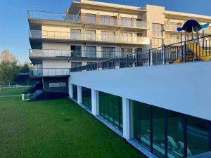 a building with a large yard in front of it at ParaSOL - Baltic Relax - Pool, Jacuzzi, Sauna in Dziwnów
