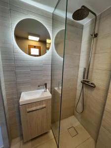 a bathroom with a sink and a shower with a mirror at Oihalia's petit DOUBLE ROOM in Khánia +7 photos