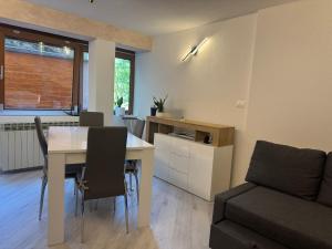 a living room with a table and a couch at Ermi Apartment Temù in Temù