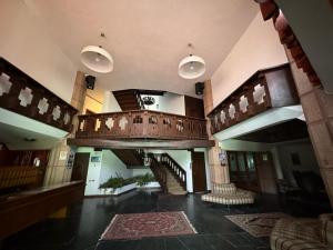 a large lobby with a staircase in a building at Ermi Apartment Temù in Temù