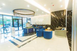 a lobby with blue chairs and a chandelier at Accra Luxury Apartments at Kass in Accra +81 photos