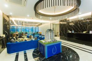 a lobby with a blue couch and a table at Accra Luxury Apartments at Kass in Accra