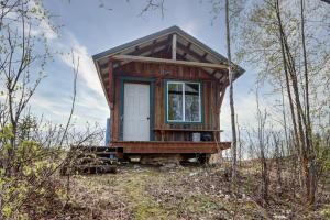 a tiny house in the middle of the woods at Bass Farm Twin Lakes Couples Dry Cabin in Wasilla