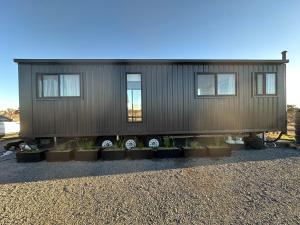 a tiny house with plants in front of it at Self-contained tiny home on acreage - 16 Belleview Dr in Murrumbateman