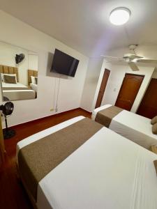 Voodi või voodid majutusasutuse Hotel Pereira Central toas