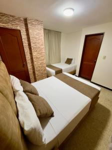Voodi või voodid majutusasutuse Hotel Pereira Central toas