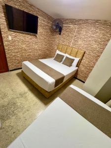Voodi või voodid majutusasutuse Hotel Pereira Central toas