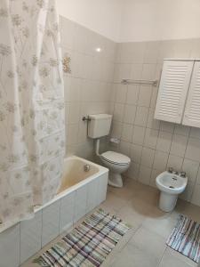 a bathroom with a toilet and a tub and a sink at La casa nel verde in Ameno +5 photos