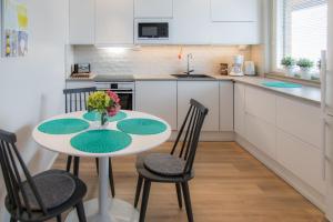 a kitchen with a table and chairs in a kitchen at Apartments Rovakatu C19 in Rovaniemi