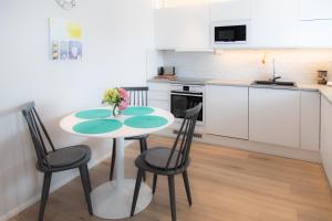 a kitchen with a table and chairs in a room at Apartments Rovakatu C19 in Rovaniemi