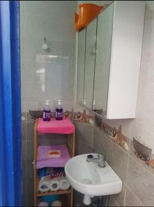 a bathroom with a sink and a mirror at Meryem Appartement in Essaouira +23 photos