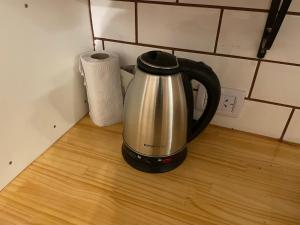 a tea kettle on a counter next to a roll of paper towels at Departamento 16 en el centro Tafi del Valle in Tafí del Valle