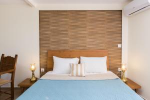 - une chambre avec un lit bleu et une tête de lit en bois dans l'établissement DTS apartment, à Réthymnon 10 autres photos