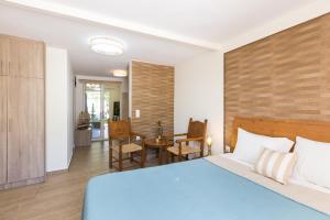 - une chambre avec un lit bleu et une table dans l'établissement DTS apartment, à Réthymnon