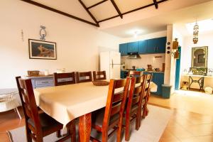 a kitchen and dining room with a table and chairs at Casinha Azul Cidade Velha - Blue House Old Town in Cidade Velha
