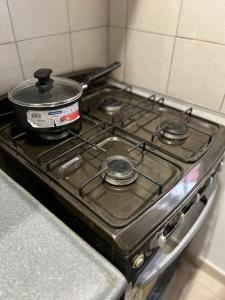 a stove top with a pot on top of it at Temporario del Sur in Santiago del Estero +7 photos