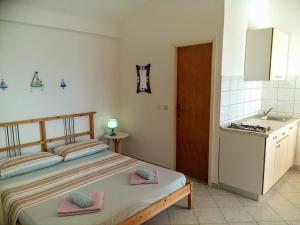 a bedroom with a bed with two towels on it at Apartments by the sea Cove Bristva, Korcula - 15205 in Blato