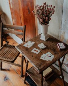 a wooden table with a vase of flowers and a chair at Book Village Inn - Entire Hotel in Hobart