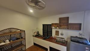 a kitchen with a sink and a bed in a room at NISETH Home in Phumĭ Réach Born (2)