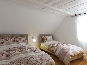 a bedroom with two beds and a window at historic Schauberhof built in 1747 