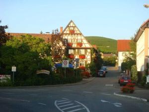 a house on a street with cars parked in front of it at 1-bedroom holiday apartment in Offenburg
