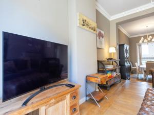 a living room with a large flat screen tv at Holiday home for 6 people with garden in Middelkerke