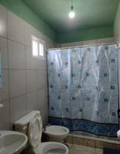 a bathroom with a toilet and a sink and a shower at Hospedaje Pringles in Santa Rosa del Conlara