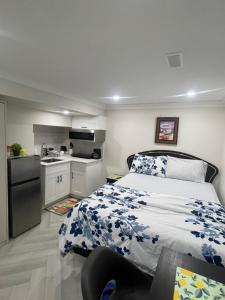 a bedroom with a bed and a small kitchen at Luxury Basement-Private Bdr & Bathroom with free parking In Toronto in Toronto