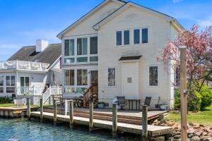 a house on the water with a dock at Waterfront Home with OC Skyline Views in Ocean City