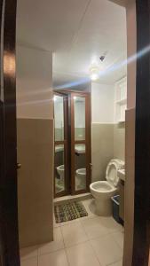 a bathroom with a toilet and a sink at Villa Brune in Baguio
