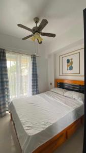 a bedroom with a bed with a ceiling fan at Villa Brune in Baguio +10 photos