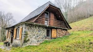 an old stone house sitting on a hill at Chalet du Temps Suspendu, Pause magique au cœur des Pyrénées in Ferrières