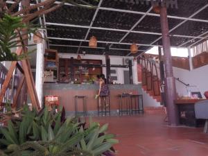 a woman standing at the bar of a restaurant at SnS Muine Homestay in Mui Ne