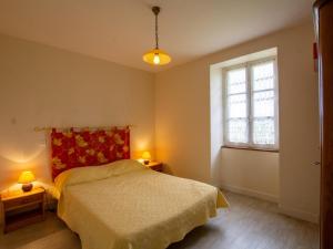 a bedroom with a bed and a window and two lamps at Maison isolée avec Terrasse, BBQ, et Jardin - Animaux acceptés - FR-1-616-154 in Villac