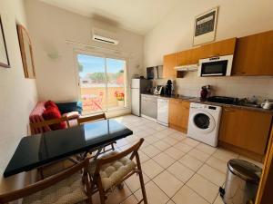 a kitchen with a table and a dining room at Argelès-sur-Mer - T2 Cabine Meublé avec Clim et Terrasse à 50m de la Plage - FR-1-309-172 in Argelès-sur-Mer +6 photos