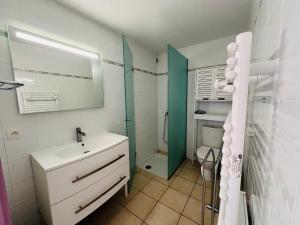a white bathroom with a sink and a shower at Argelès-sur-Mer - T2 Cabine Meublé avec Clim et Terrasse à 50m de la Plage - FR-1-309-172 in Argelès-sur-Mer