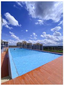 a large swimming pool on the roof of a building at Alpha homes in Gatunga
